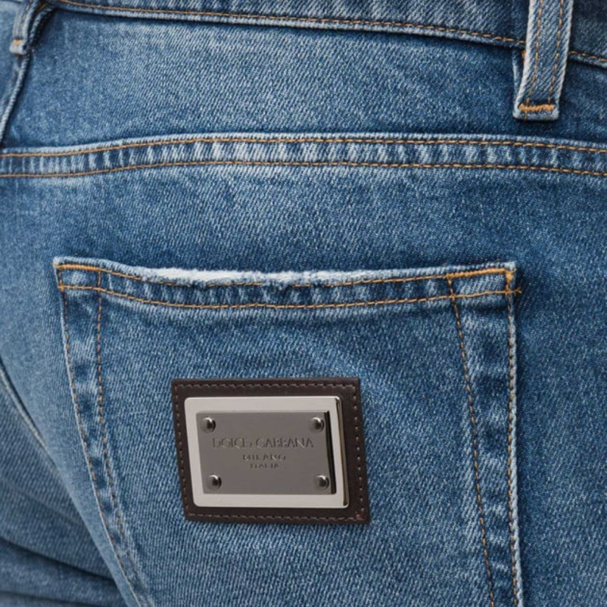 Jean slim DOLCE & GABBANA coton stretch bleu délavé logo plaque métal