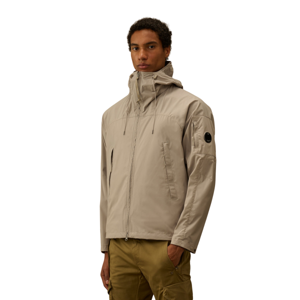 Blouson zippé à capuche CP COMPANY Pro-Tek gris beige lentille poche manche