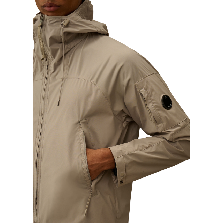 Blouson zippé à capuche CP COMPANY Pro-Tek gris beige lentille poche manche